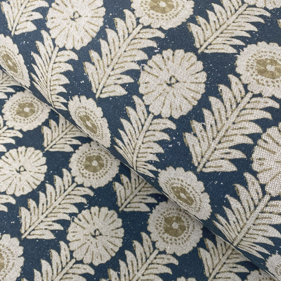 A folk-inspired block print style design with a stylised floral motif in indigo blue. A versatile mid scale design printed suitable for curtains and blinds.