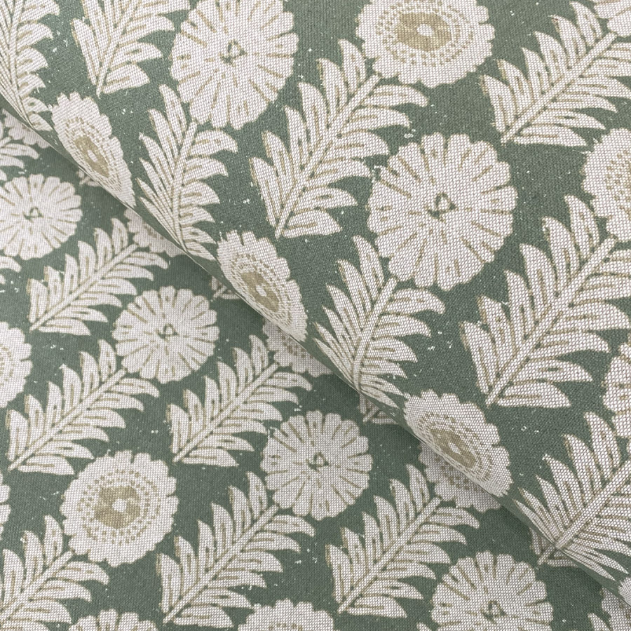 A folk-inspired block print style design with a stylised floral motif in green. A versatile mid scale design suitable for curtains and blinds.