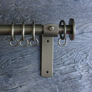a slim bronze metal curtain pole