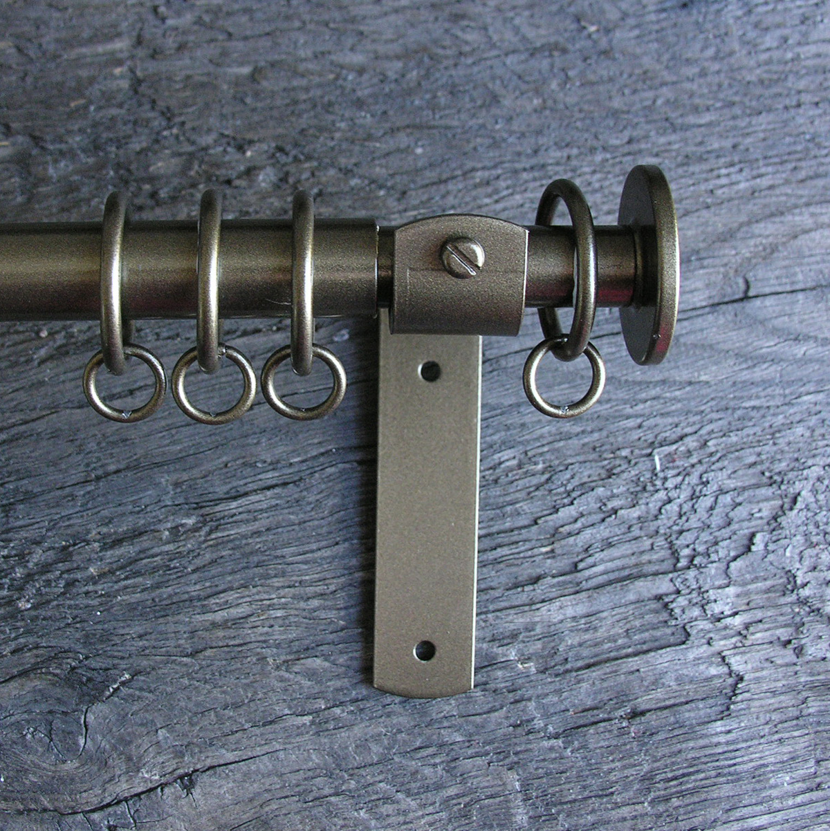 a slim bronze metal curtain pole