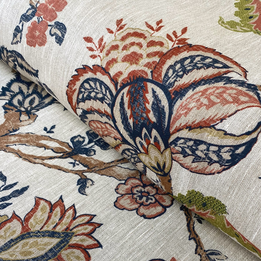 Large scale Tree of Life curtain fabric printed on 100% linen, featuring stylised leaves and branches in rich blues and reds.