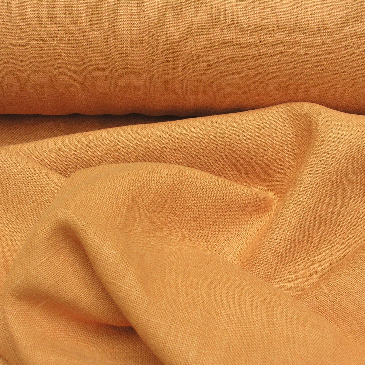 100% Linen fabric with a super soft drape in orange. This mid weight linen is suitable for curtains and blinds where a good drape is uppermost.