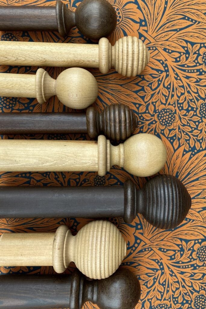 a range of wooden Curtain Poles with different finials
