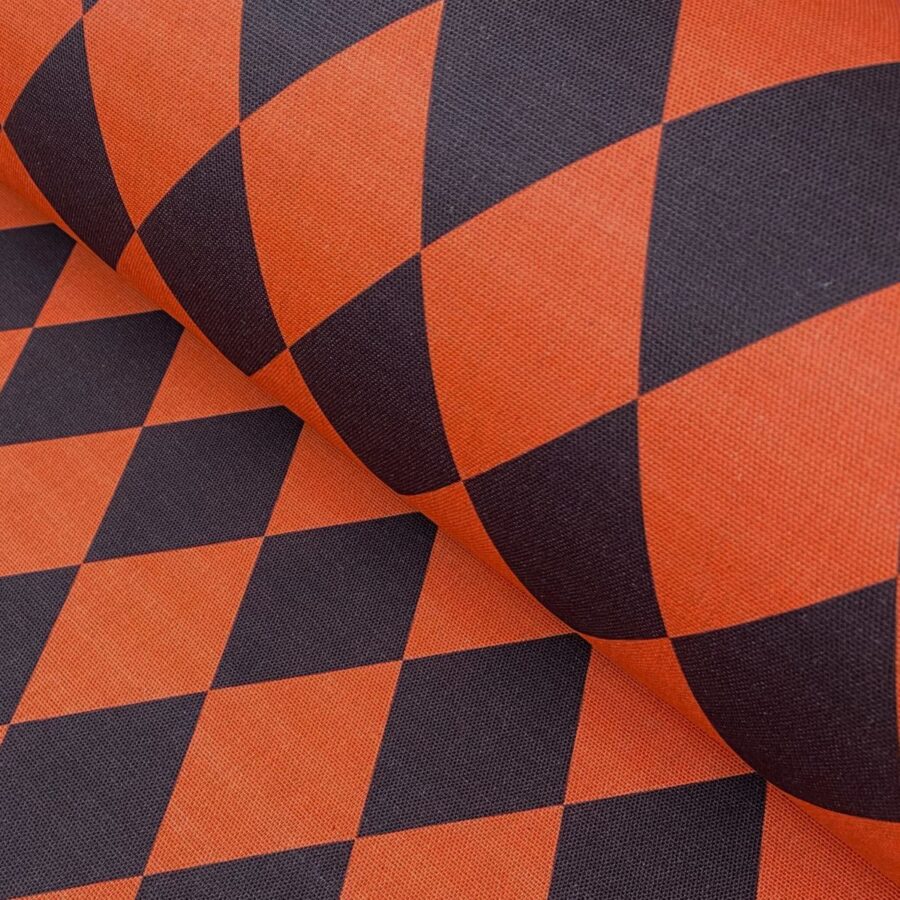 Harlequin pattern fabric in orange and brown like a cinnabar moth