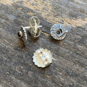 Silver disc earrings with citrine centre on a wooden background