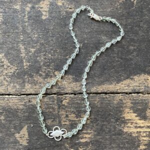 Amethyst & Silver beaded necklace on a wooden background