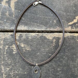 Silver pendant necklace on a wooden background