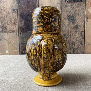 Carole Glover slipware glazed Ozzy Owl against a wooden background