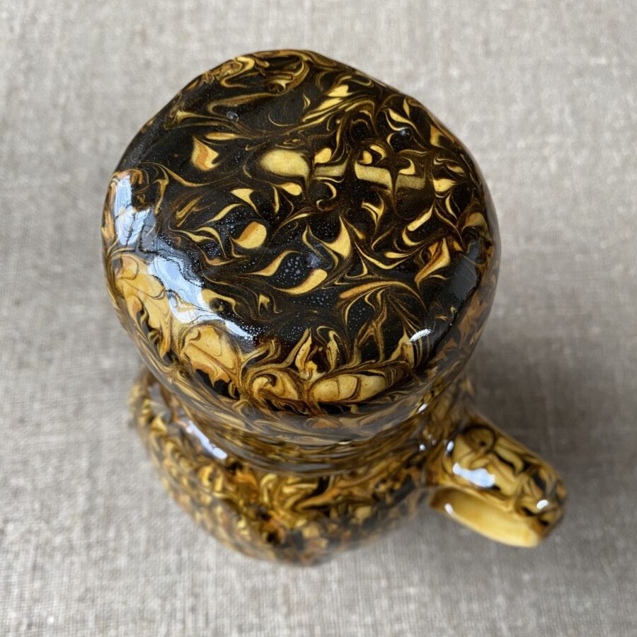 Carole Glover slipware glazed Ozzy Owl against a wooden background
