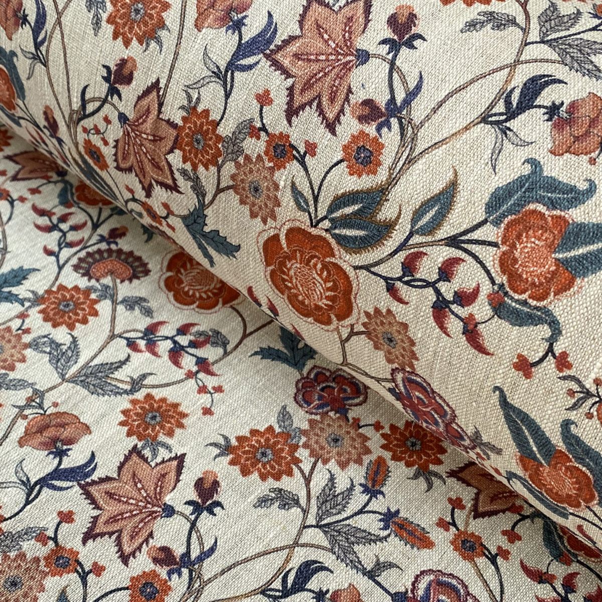 Melody Linen Print fabric in teal & orange on a roll