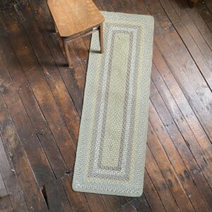 Braided jute runner lying on a wooden floor with a wooden chair on top