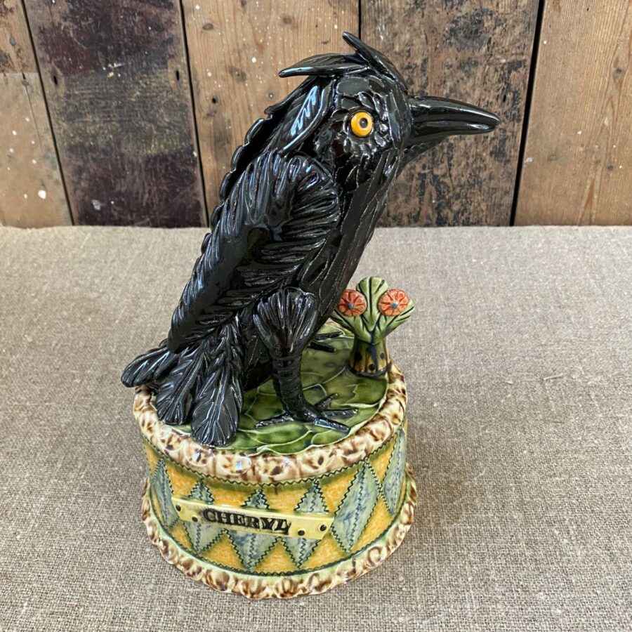 Ceramic slipware black crow on a patterned plinth by Paul Young
