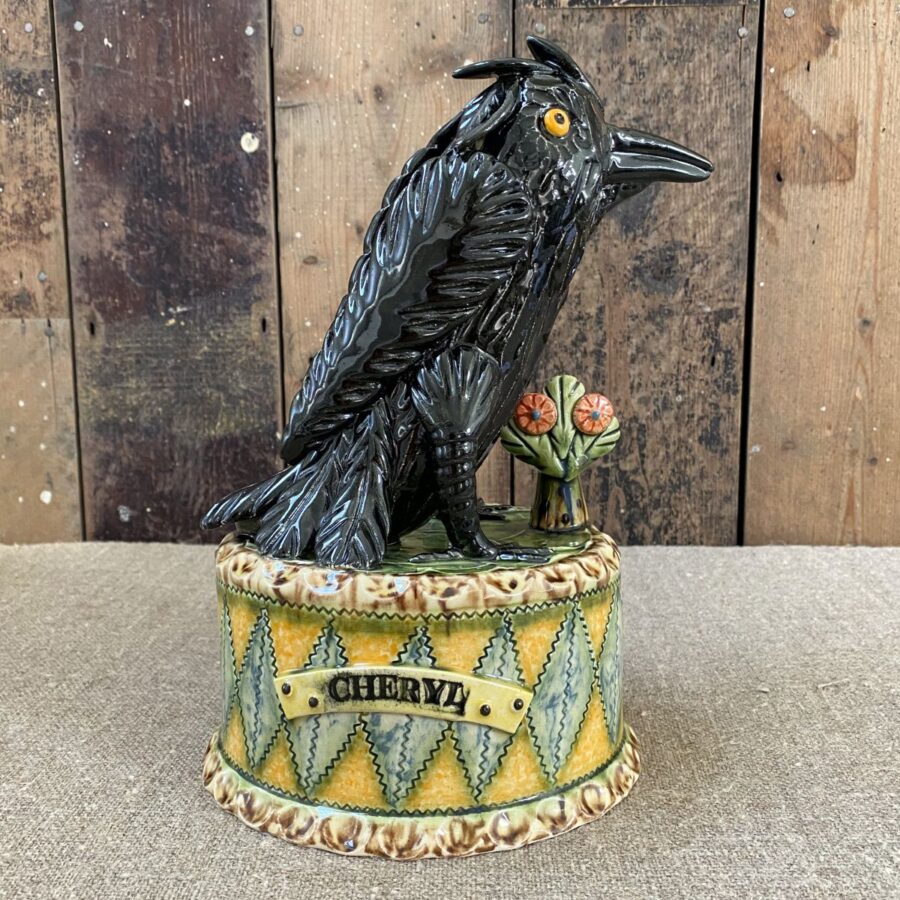 Ceramic slipware black crow on a patterned plinth by Paul Young