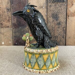 Ceramic slipware black crow on a patterned plinth by Paul Young