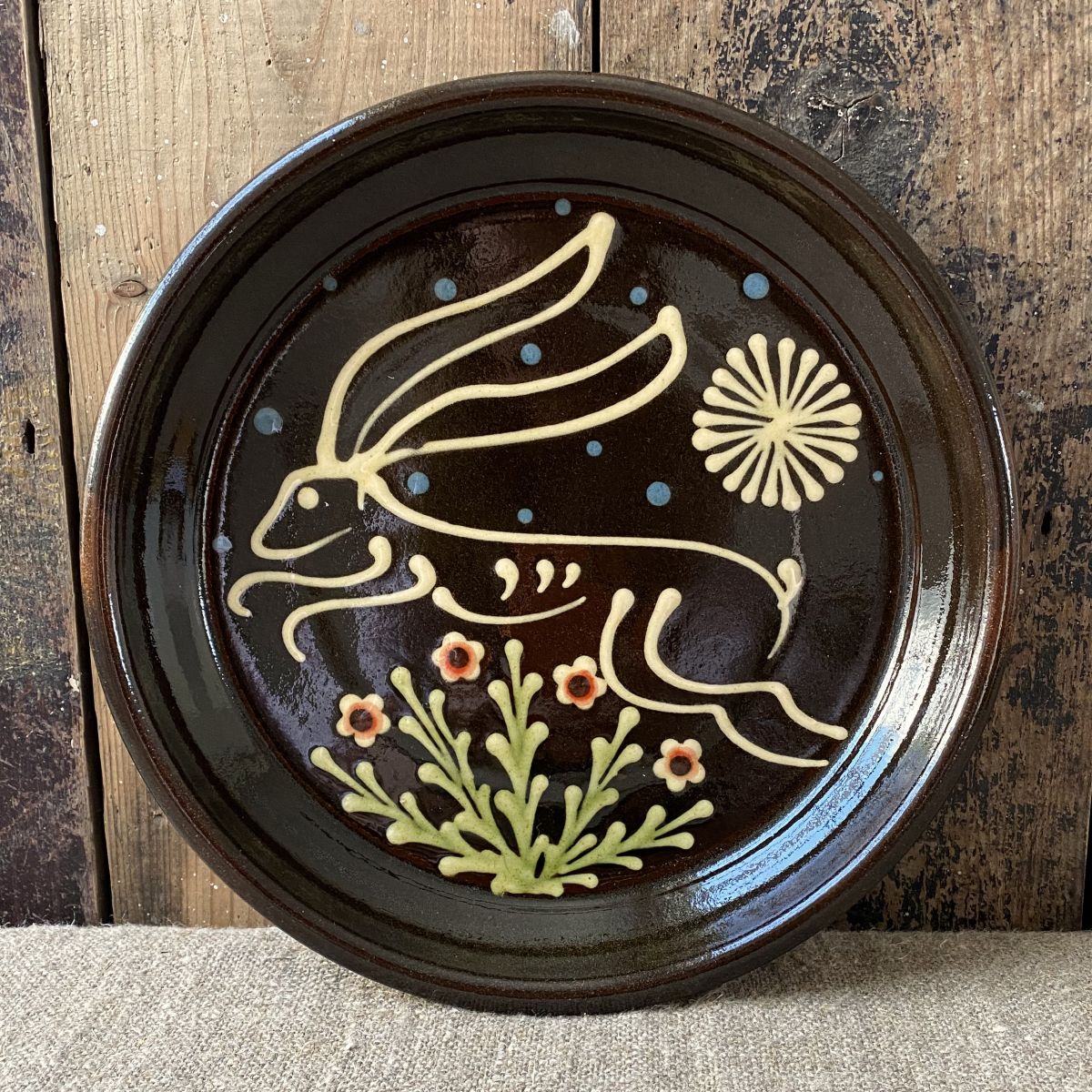 Ceramic slipware plate with a hare design by Paul Young