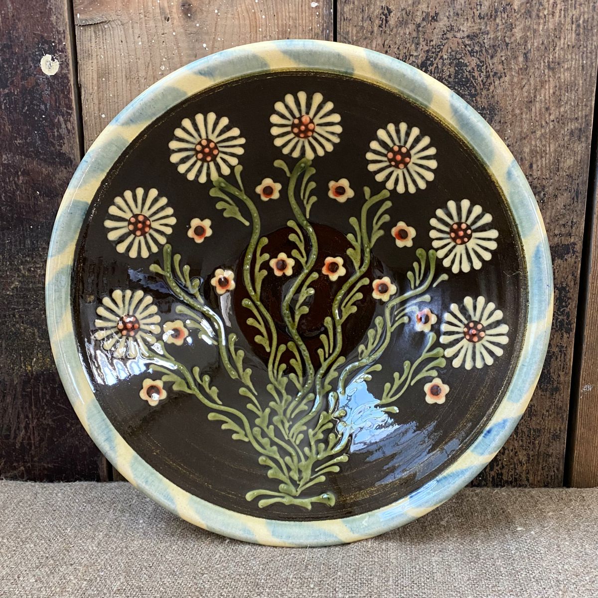 Highly detailed, ceramic slipware daisy bowl by Paul Young