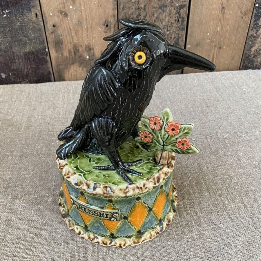 Ceramic slipware black crow on a patterned plinth by Paul Young