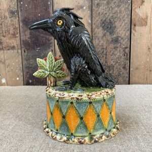 Ceramic slipware black crow on a patterned plinth by Paul Young