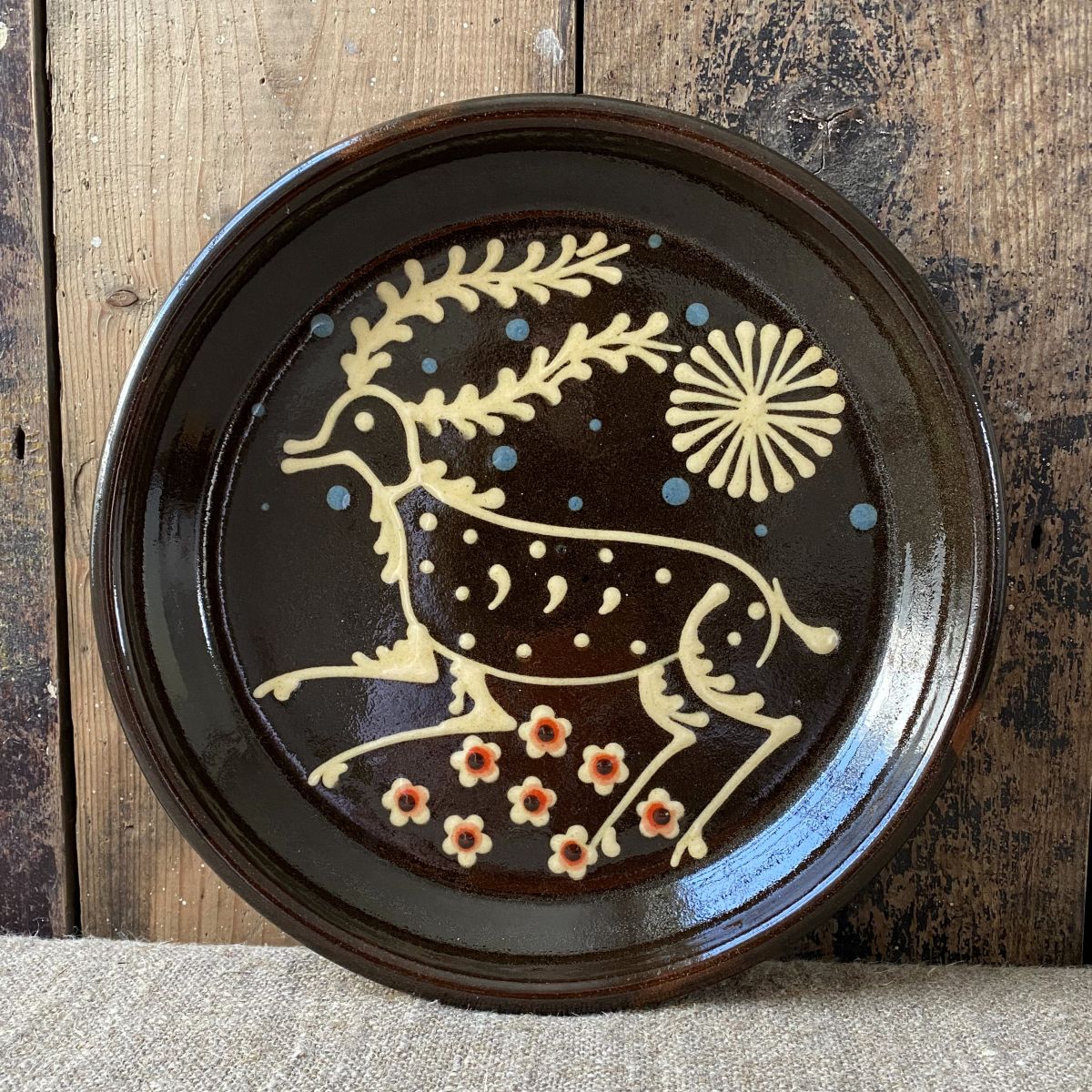 Ceramic slipware plate with a STAG design by Paul Young