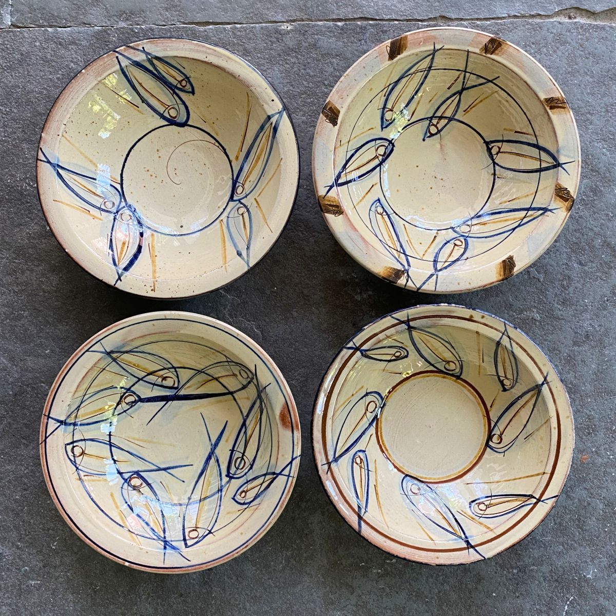 Jennifer Hall slipware breakfast bowls from above on a stone background
