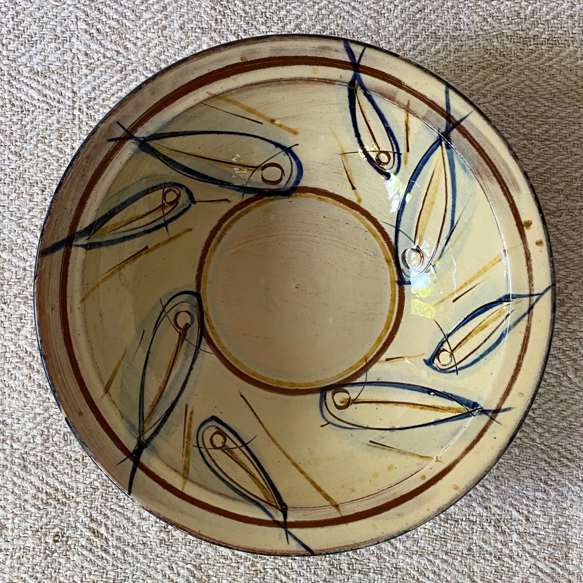 Jennifer Hall slipware breakfast bowls from above on a cream textile background
