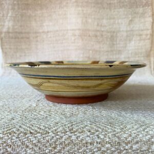 Jennifer Hall Slipware pasta bowl from the side on a cream textile background