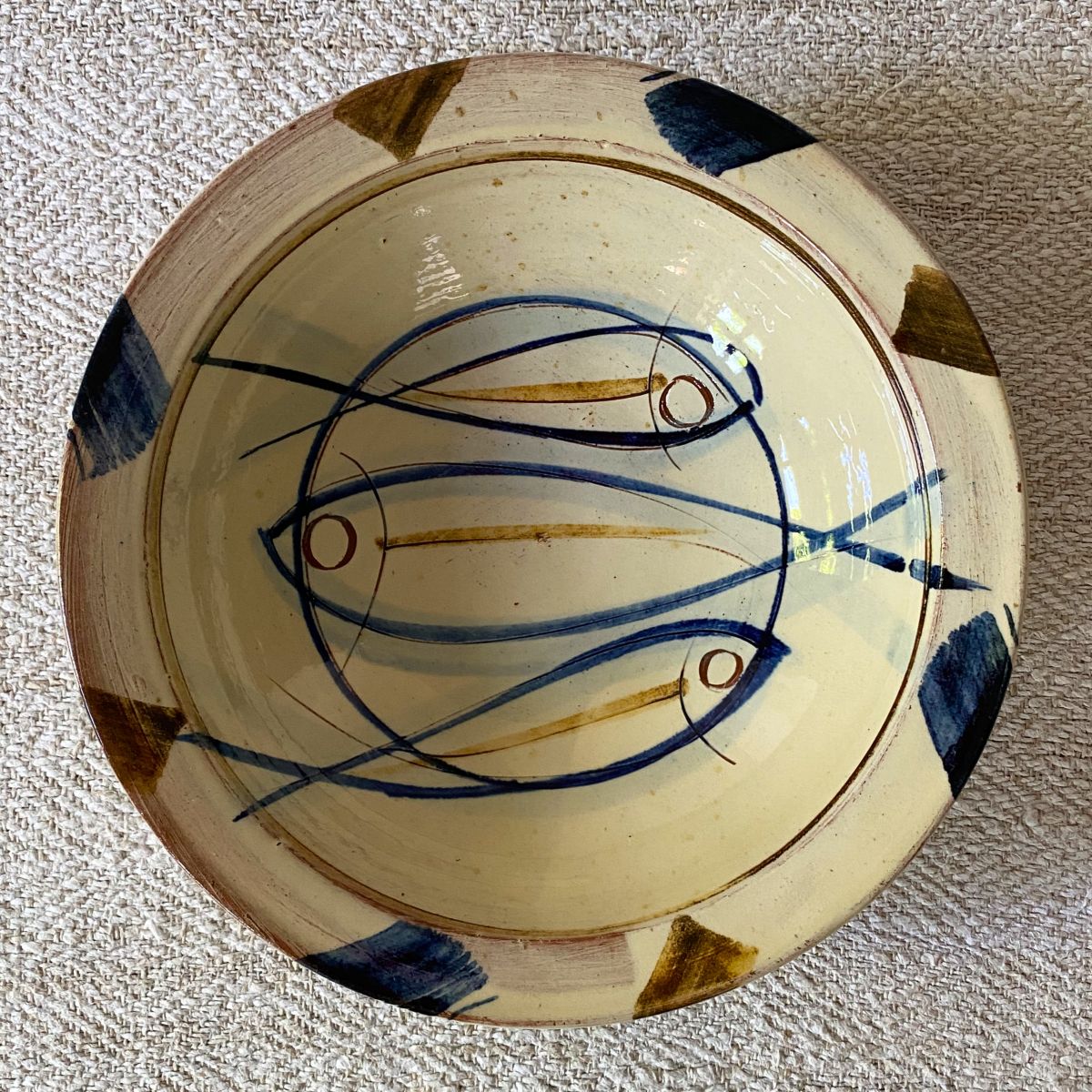 Jennifer Hall Slipware pasta bowl from above on a cream textile background