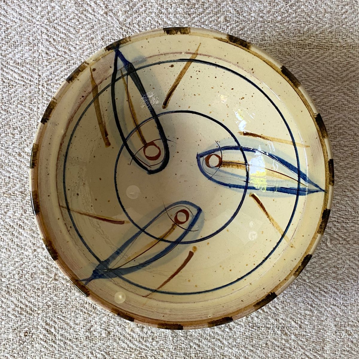 Jennifer Hall Slipware pasta bowl from above on a cream textile background