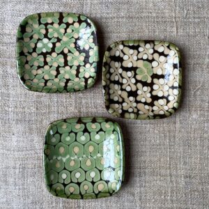 Patia Davis Biscuit plate trio with brown glaze base on linen backcloth