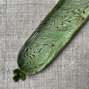 Patia Davis extra long oval platter with green glaze on linen backcloth