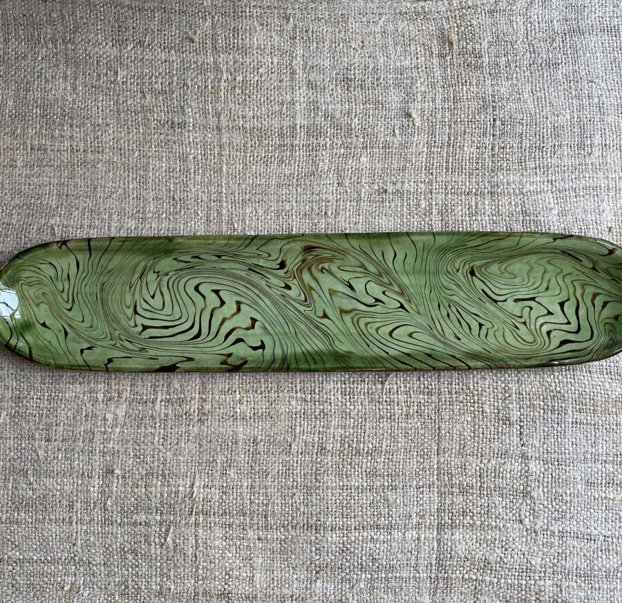 Patia Davis extra long oval platter with green glaze on linen backcloth