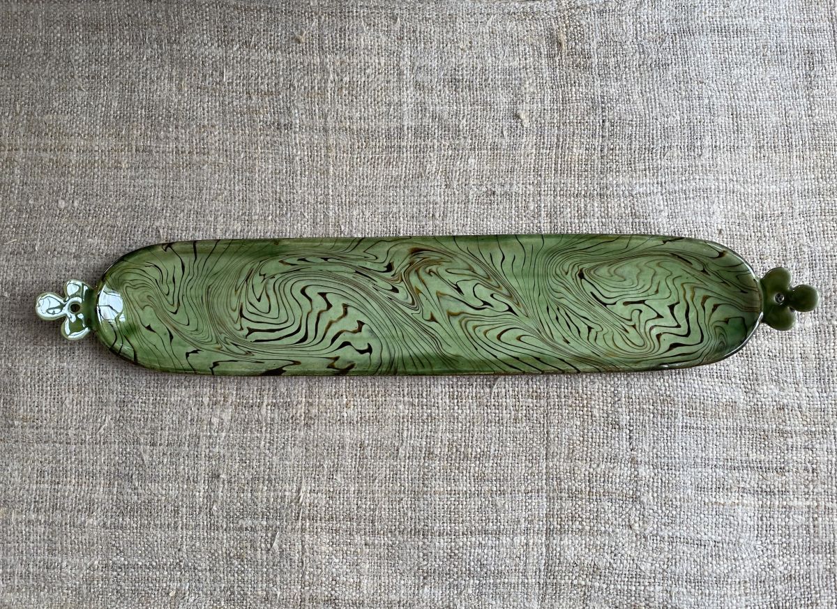 Patia Davis extra long oval platter with green glaze on linen backcloth