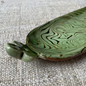 Patia Davis extra long oval platter with green glaze on linen backcloth