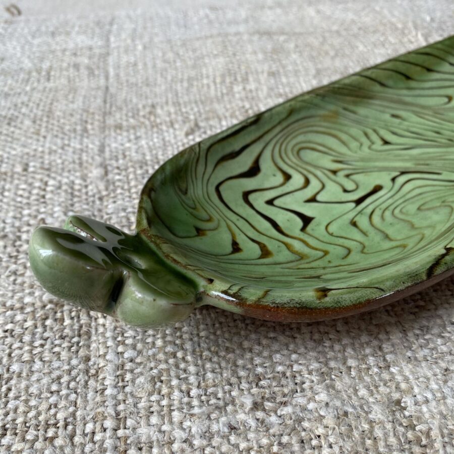 Patia Davis extra long oval platter with green glaze on linen backcloth