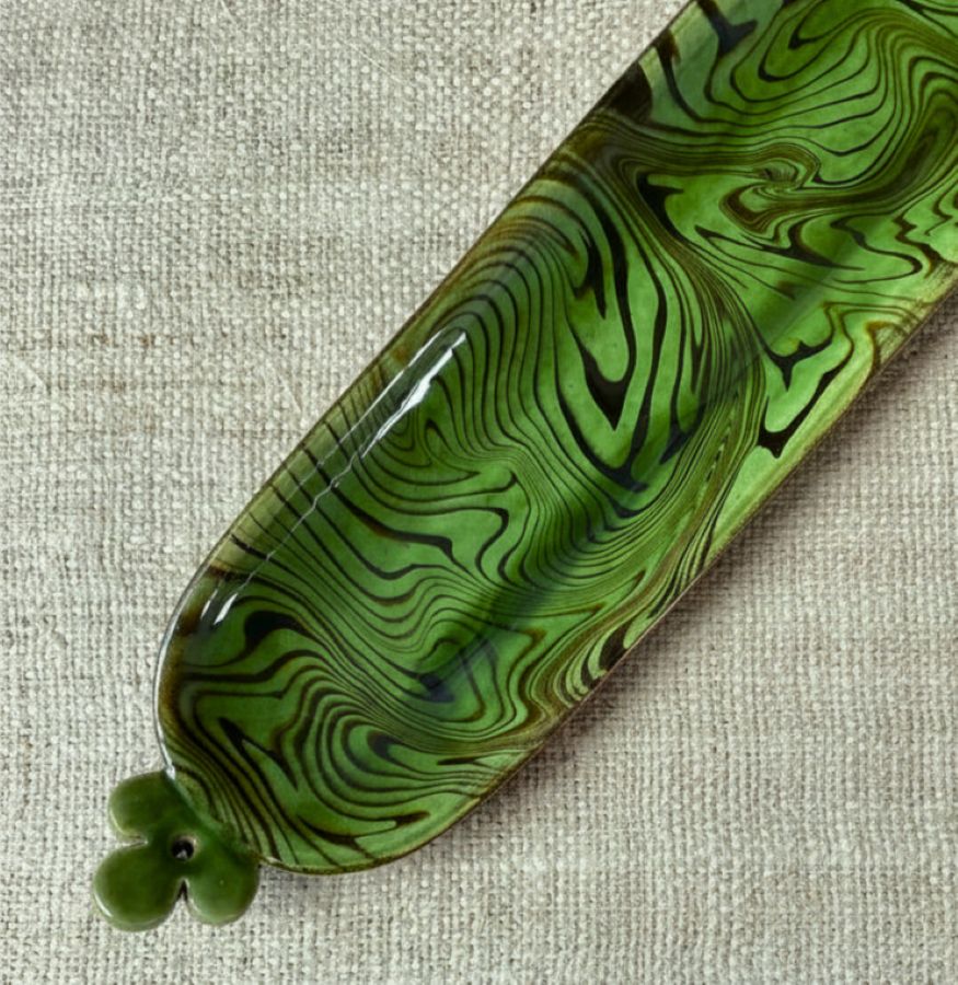 Patia Davis extra long oval platter with green glaze on linen backcloth