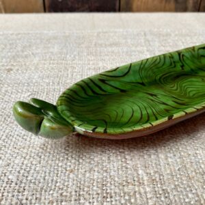 Patia Davis extra long oval platter with green glaze on linen backcloth