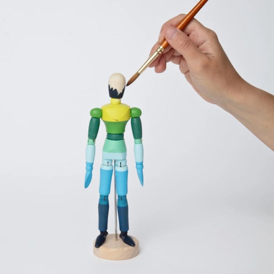 Paint & Pose Mannequin being painted with a small paintbrush