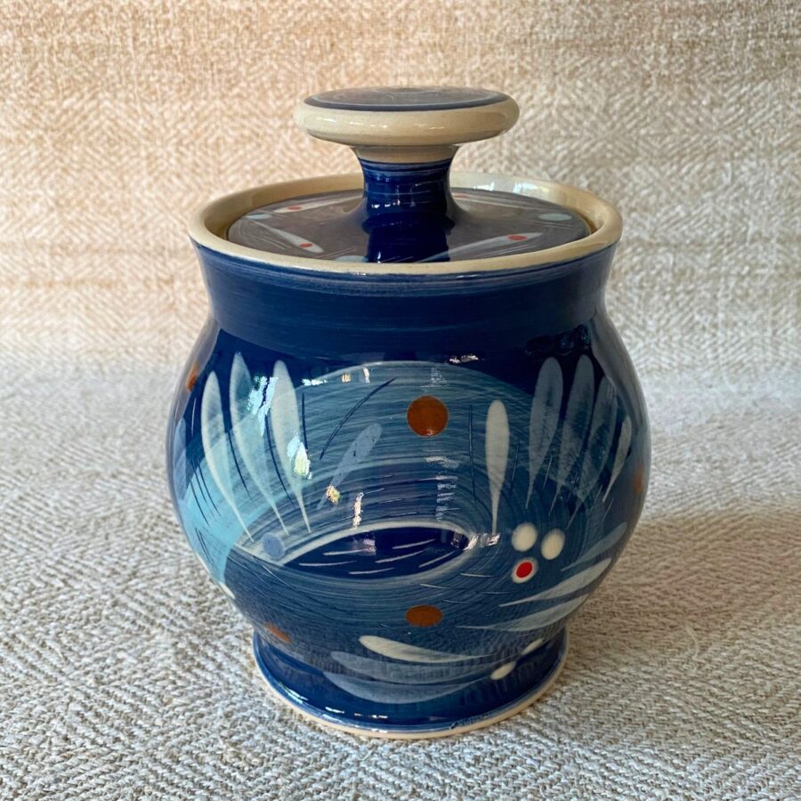 RAMP Ceramics earthenware caddy jar in a blue abstract design on a cream textile backdrop.