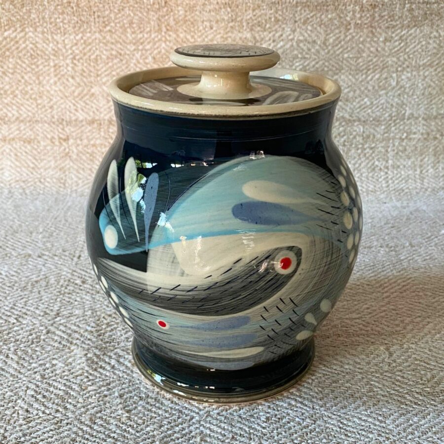 RAMP Ceramics earthenware caddy jar in a blue abstract design on a cream textile backdrop.