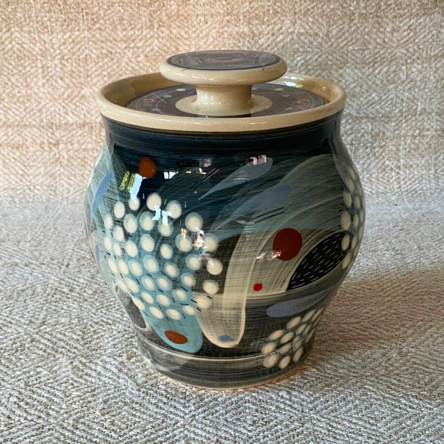RAMP Ceramics earthenware caddy jar in a blue abstract design on a cream textile backdrop.