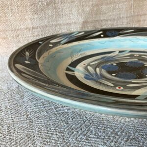 RAMP Colourful blue platter on cream textile background