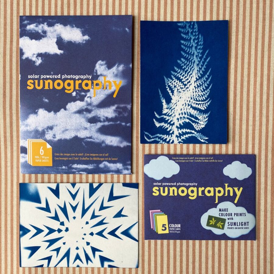 Cyanotype Sunography papers with examples on striped backcloth