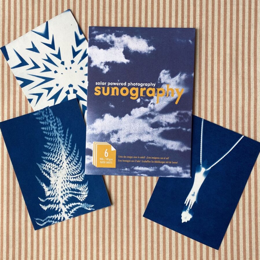 Cyanotype Sunography papers with examples on striped backcloth
