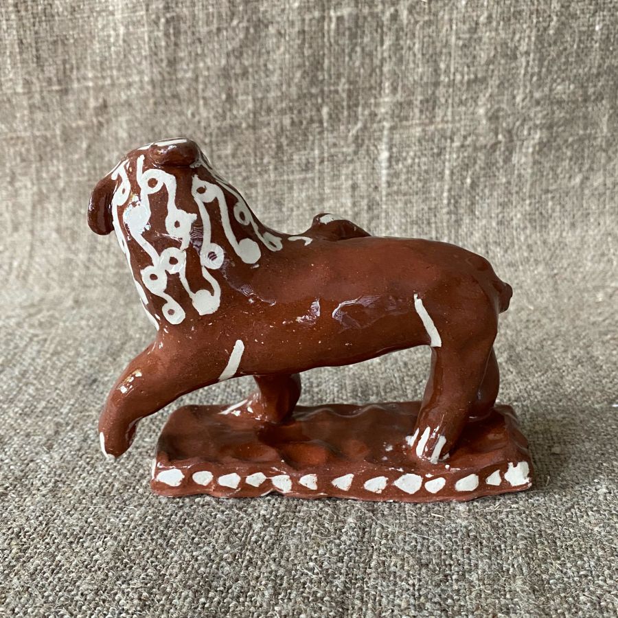 Emma Carlow upright lion pottery whistle against fabric background