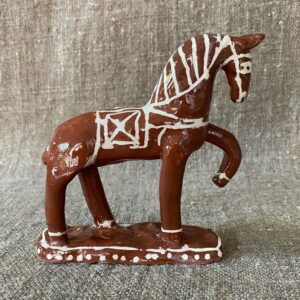 Emma Carlow horse pottery whistle against fabric background