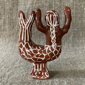 Emma Carlow mermaid pottery whistle against fabric background