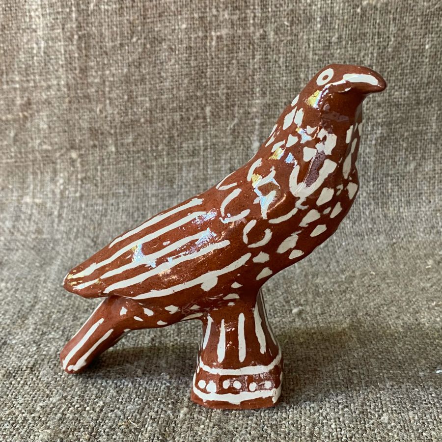 Emma Carlow bird pottery whistle against fabric background