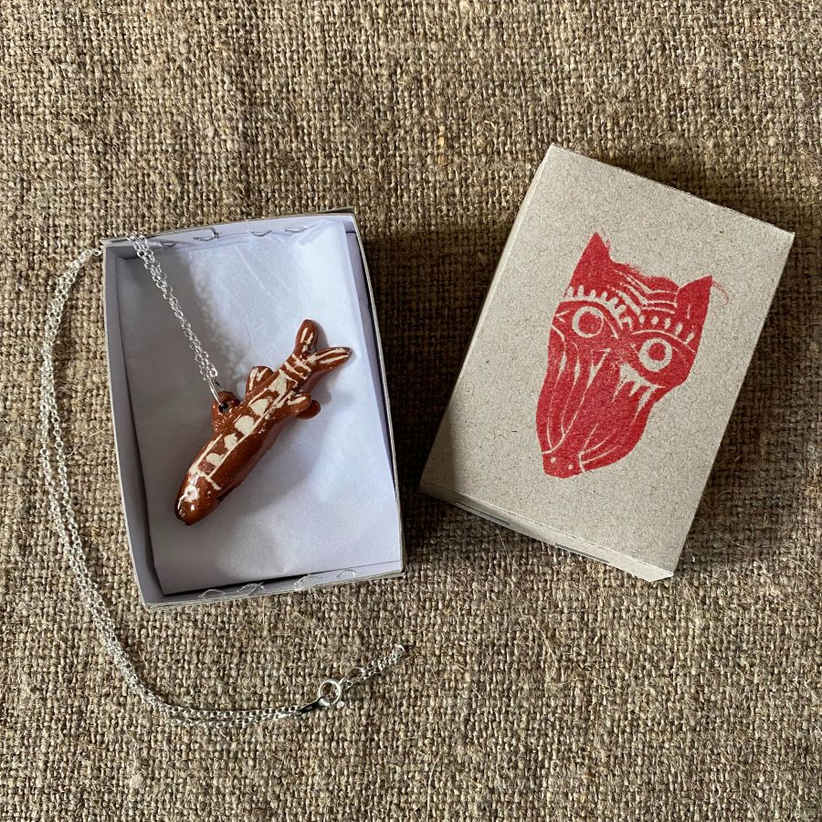 Emma Carlow Tiny clay whistle on a fabric background - Fish
