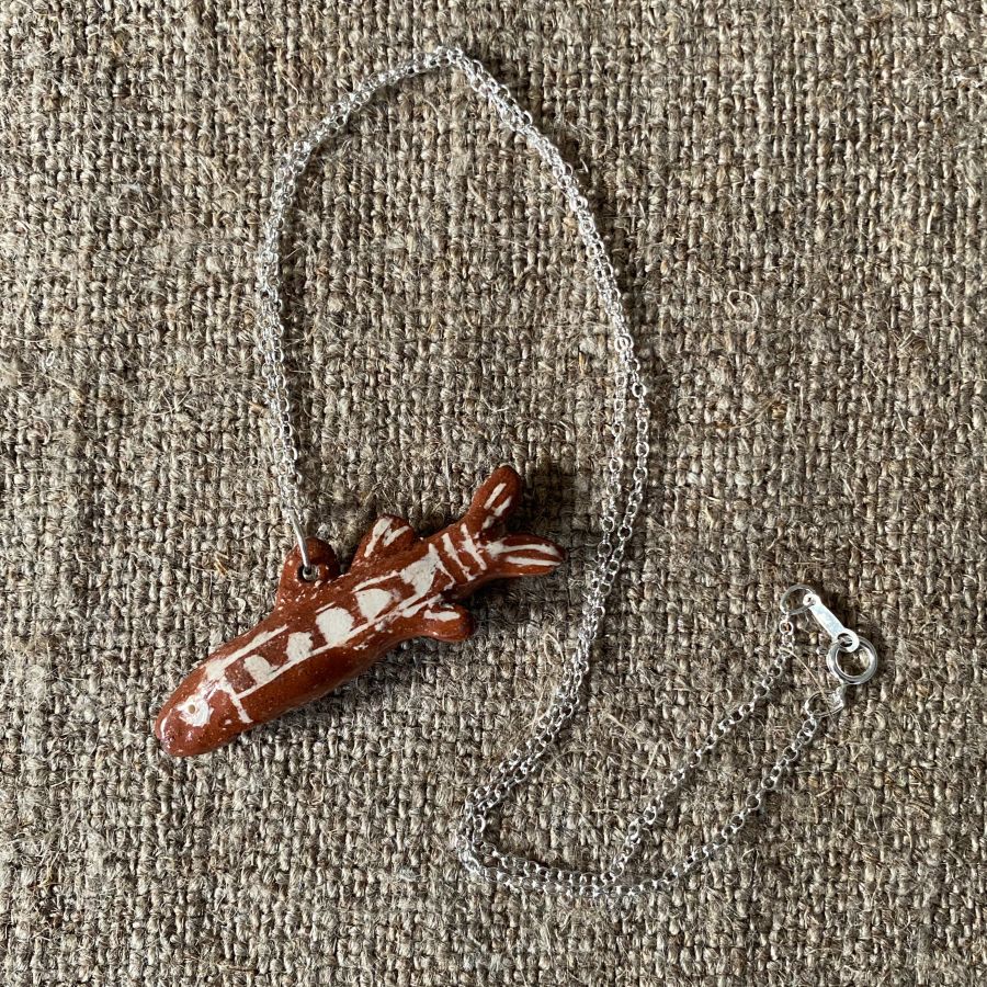 Emma Carlow Tiny clay whistle on a fabric background - Fish