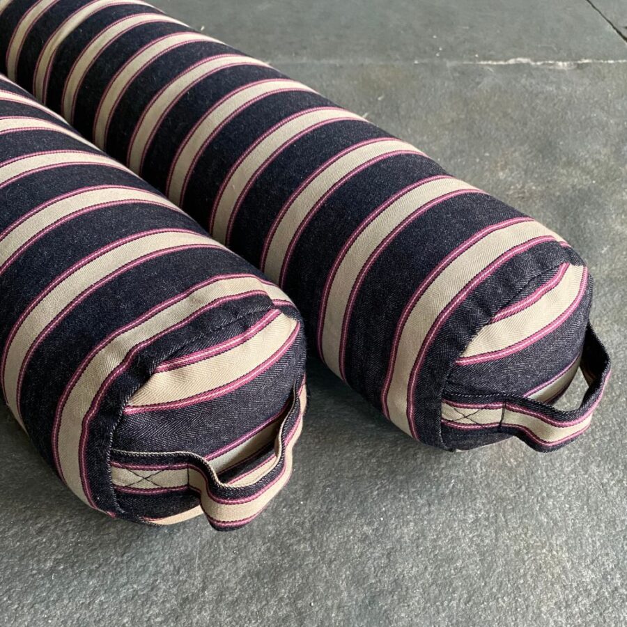 Pair of Striped Draught Excluders on a grey stone floor